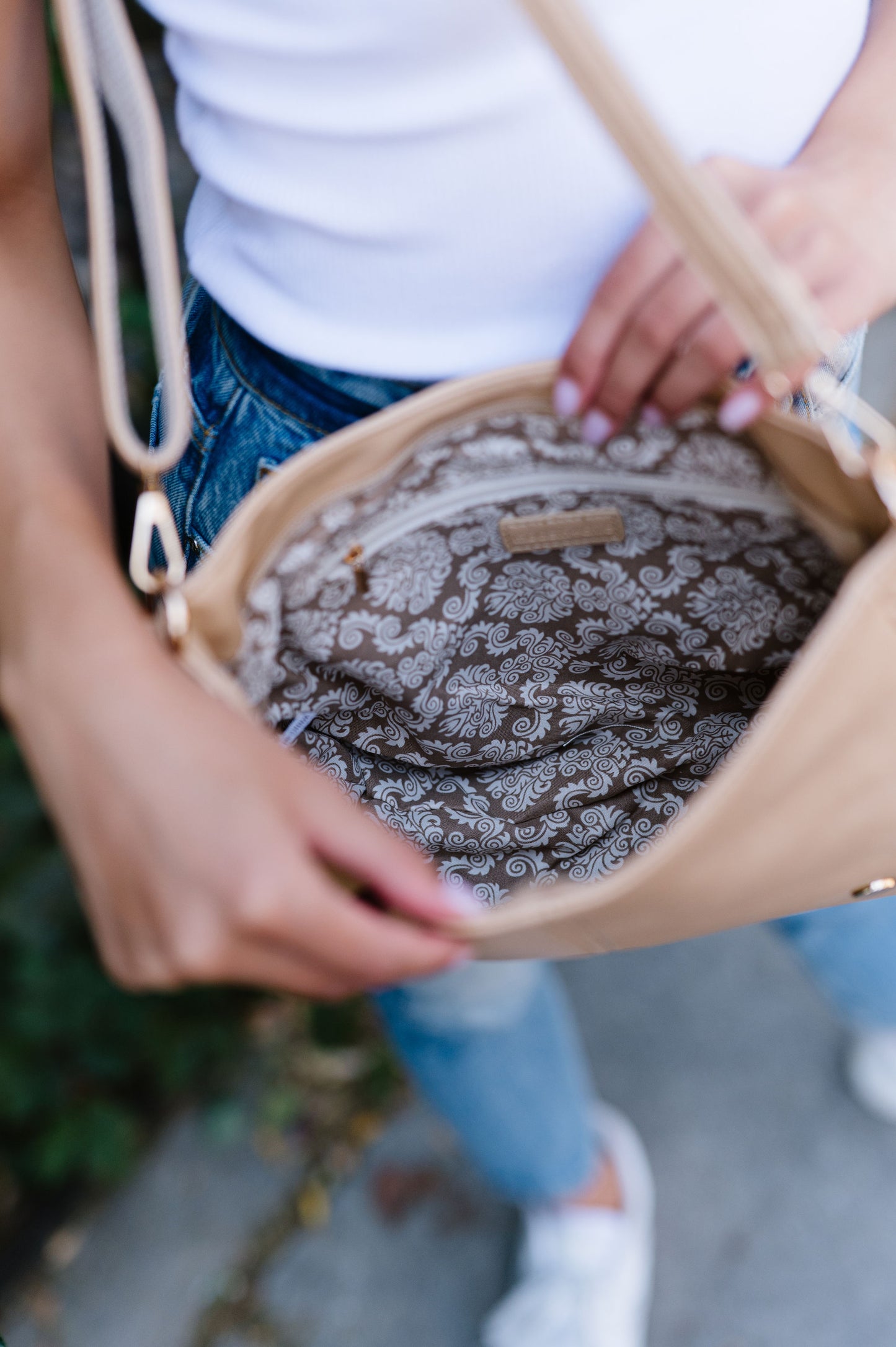 An interior shot of a vegan leather crossbody showing an interior zippered pocket.