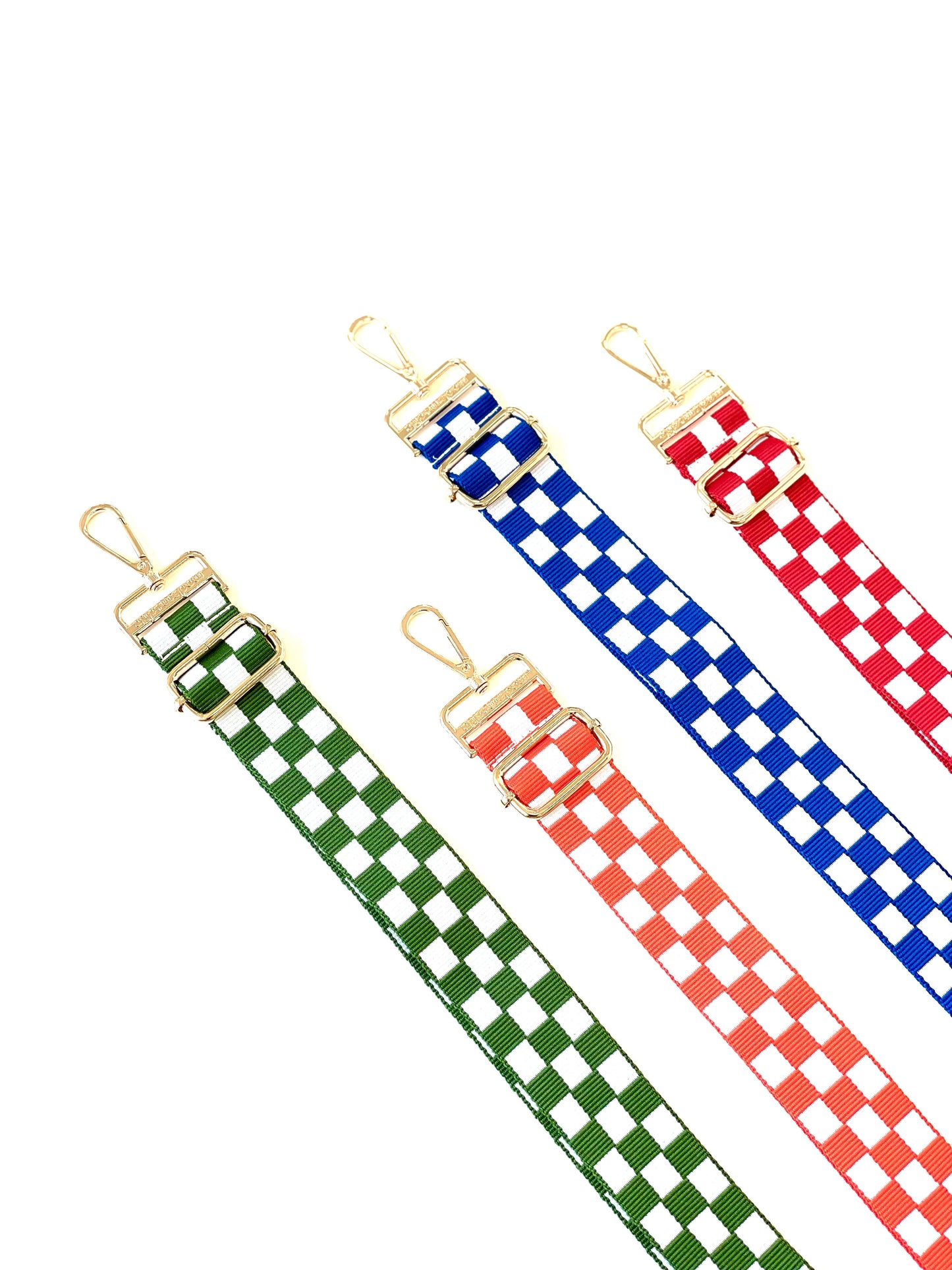 Four Modern + Chic Lizzie Checkered Purse Straps for Crossbody Bags on a white background in the colors green and white, orange and white, blue and white and red and white.