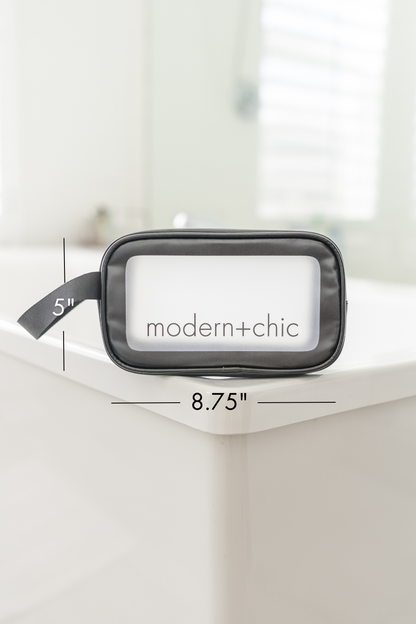 A small rectangular clear cosmetic bag with a handle.