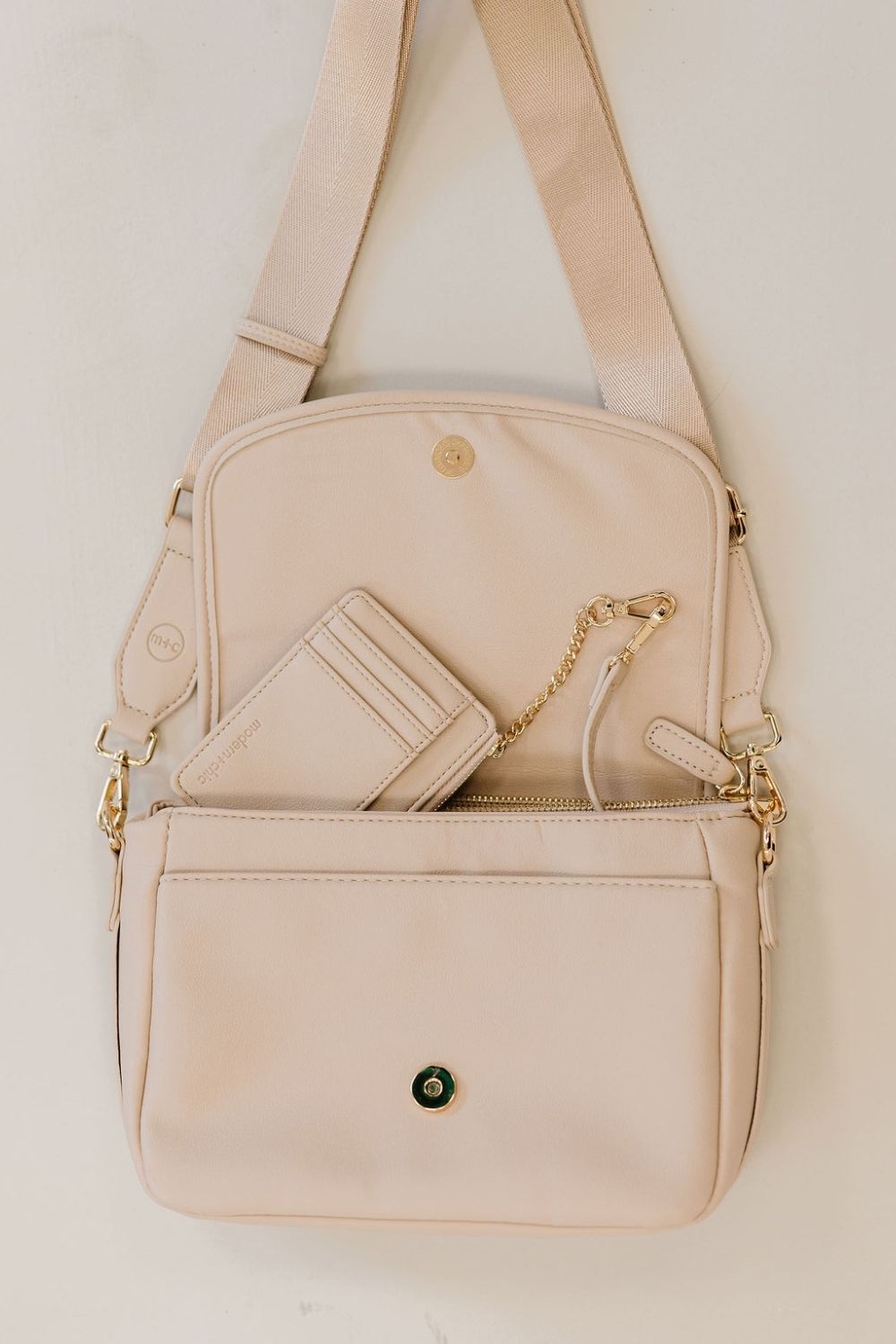 A cream crossbody and matching wallet.