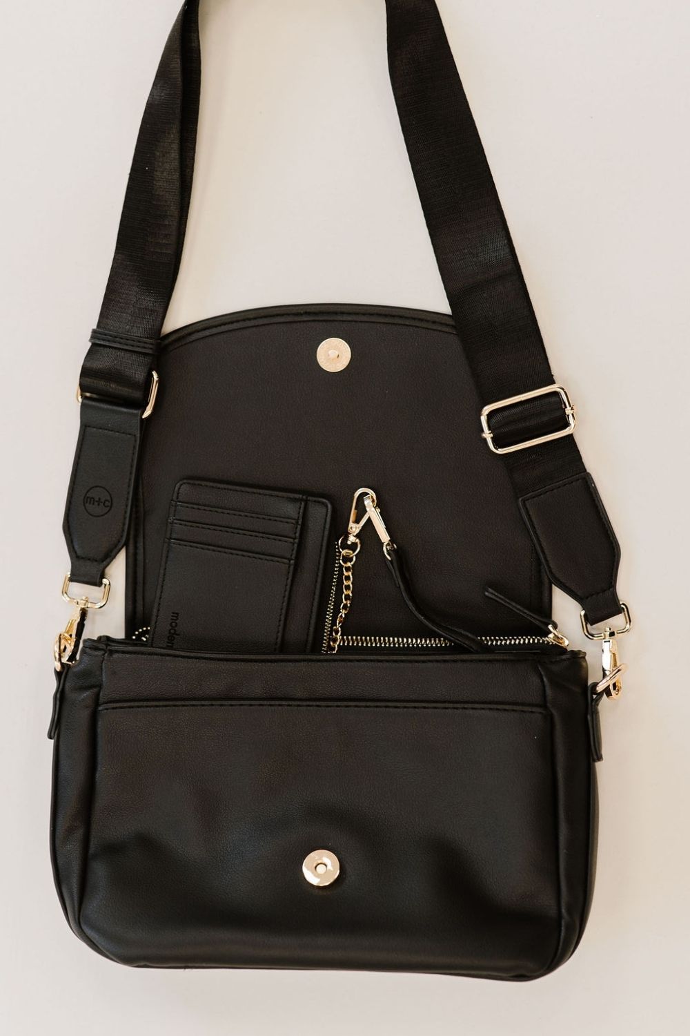 A black crossbody bag and matching wallet.