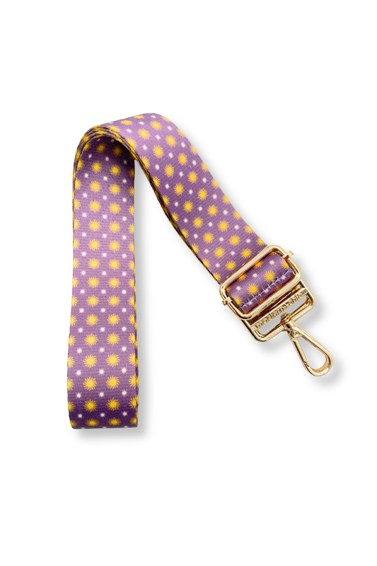 Modern + Chic Gleam & Glow Adjustable Purse Strap for Crossbody Bags, purple in color with gold suns and white polka dots on a white background.