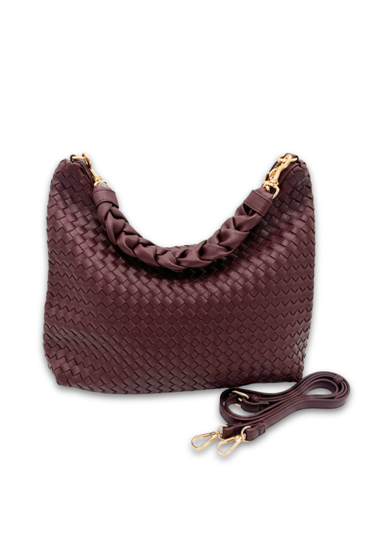 Red plum colored woven handbag with a matching strap on a white background