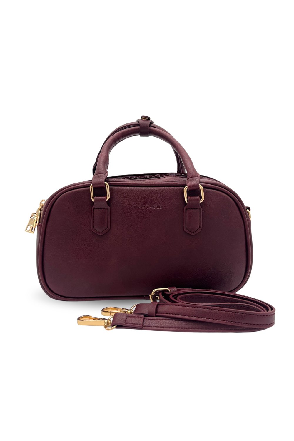 A wine Modern + Chic Remi Vegan Leather Crossbody Purse with gold hardware on white background. 
