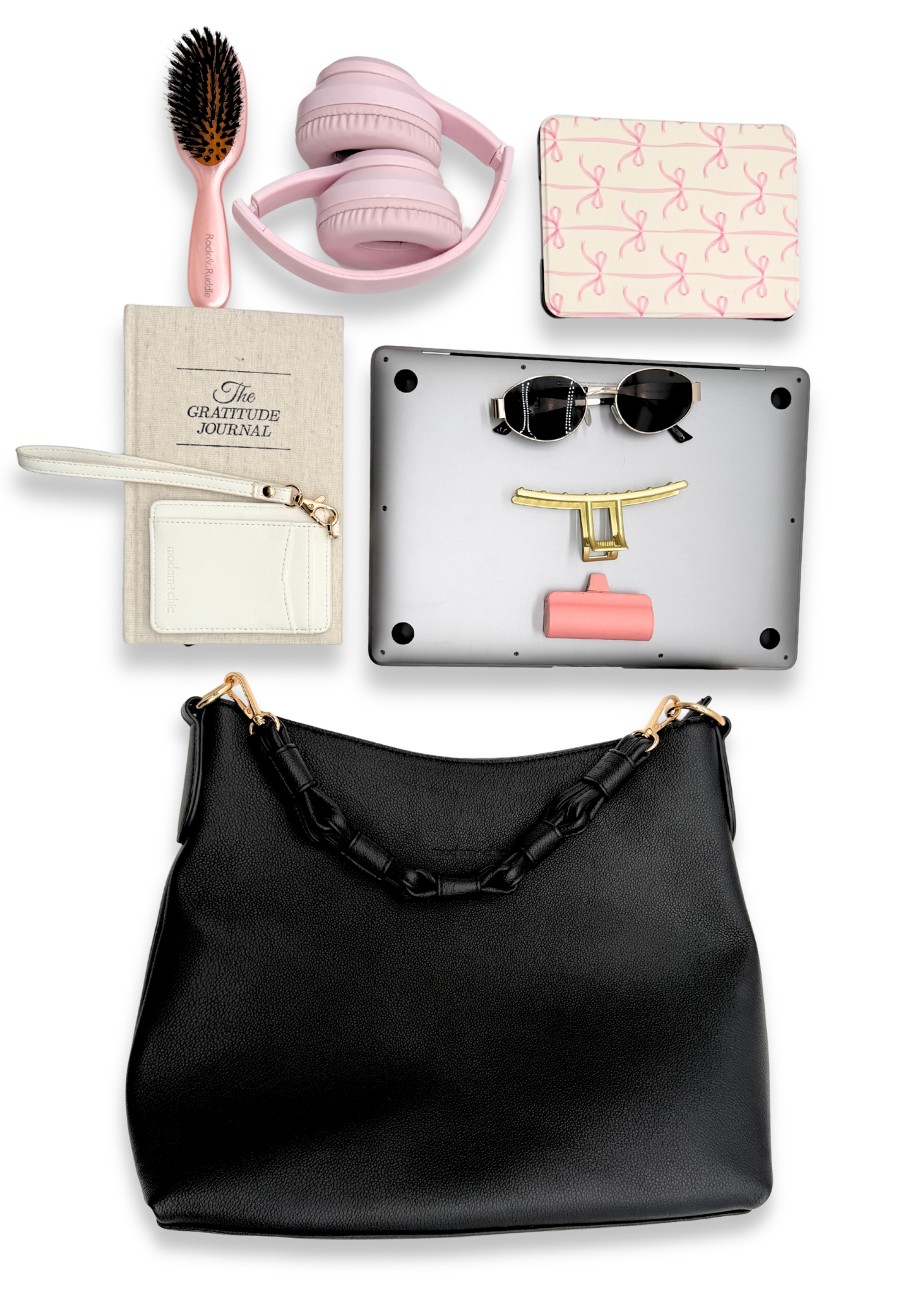 Black Modern+Chic Sawyer Convertible Slouchy Tote Bag for Women with various accessories including a hairbrush, headphones, and a laptop on a white background. 