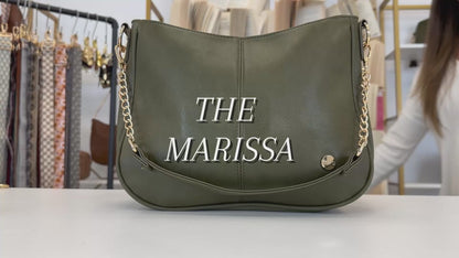 A video showing the features and benefits of a Modern + Chic Marissa Vegan Leather Crossbody Handbag with gold chain accents. 