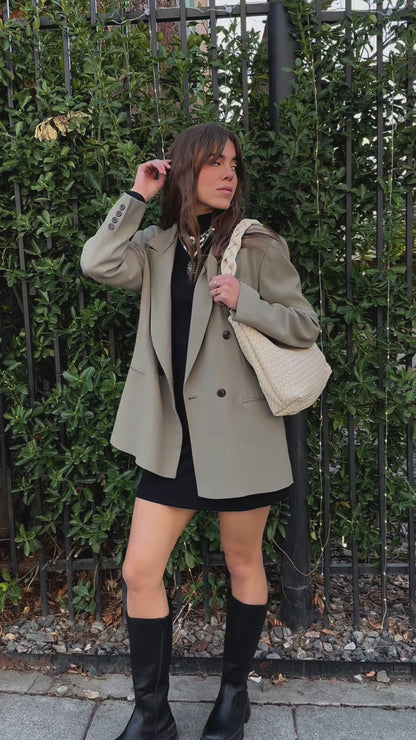 A video of a woman modeling an ivory Modern+Chic Kelly Woven Convertible Crossbody Shoulder Bag with included vegan leather adjustable crossbody strap outdoors.